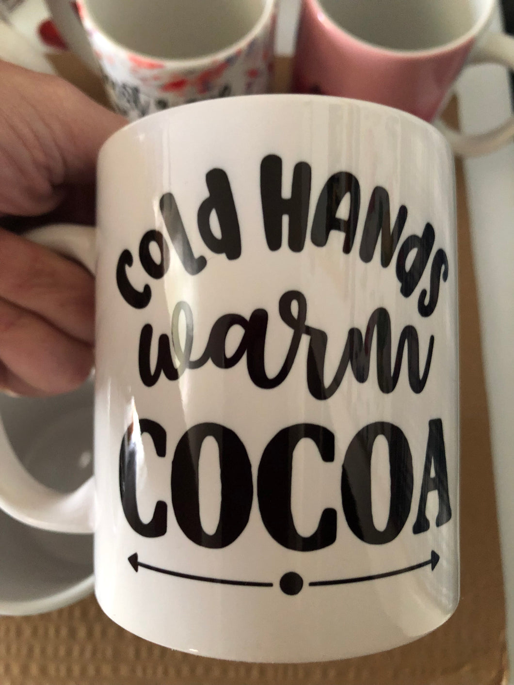 Cold hands warm cocoa mug